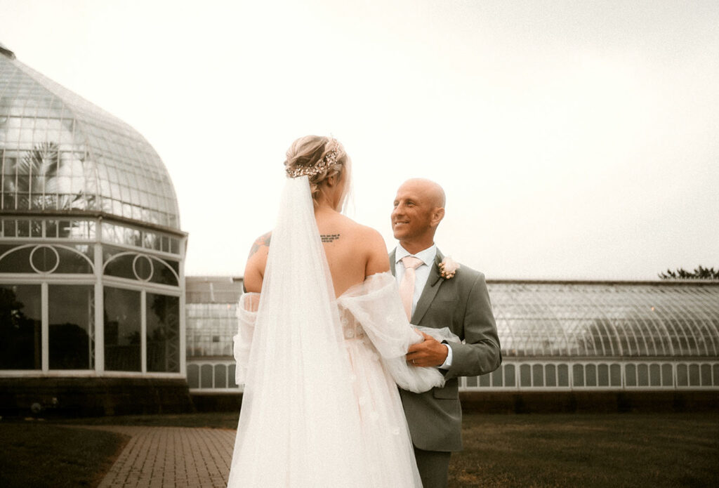 Bride and Groom Stand outside of Phipps Conservatory after their Wedding