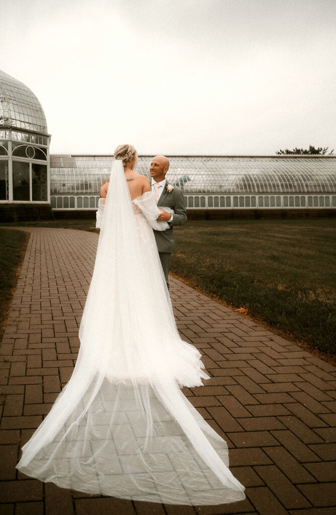 Bride and Groom Stand outside of Phipps Conservatory after their Wedding