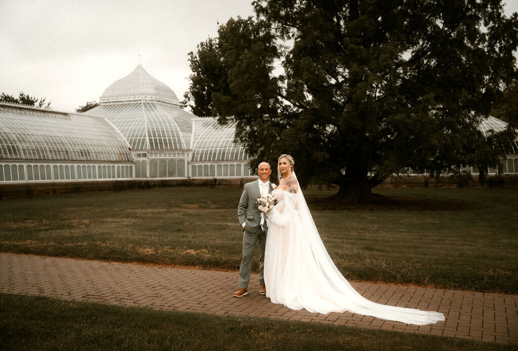 Bride and Groom Stand outside of Phipps Conservatory after their Wedding