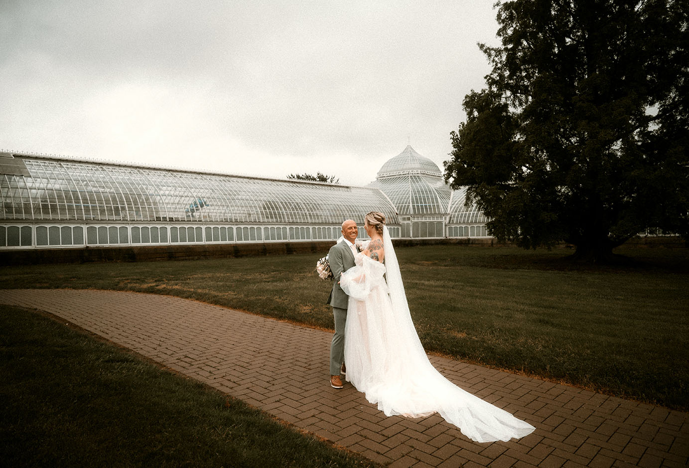 Bride and Groom Stand outside of Phipps Conservatory after their Wedding