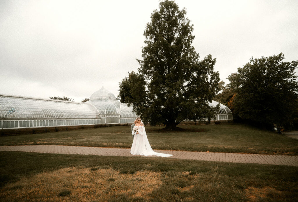 Bride and Groom Stand outside of Phipps Conservatory after wedding