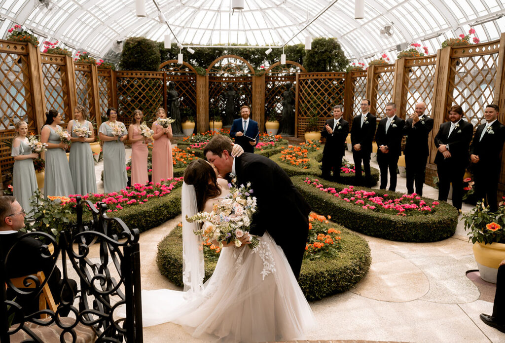 Bride and Groom Kiss at their wedding ceremony at Phipps Conservatory