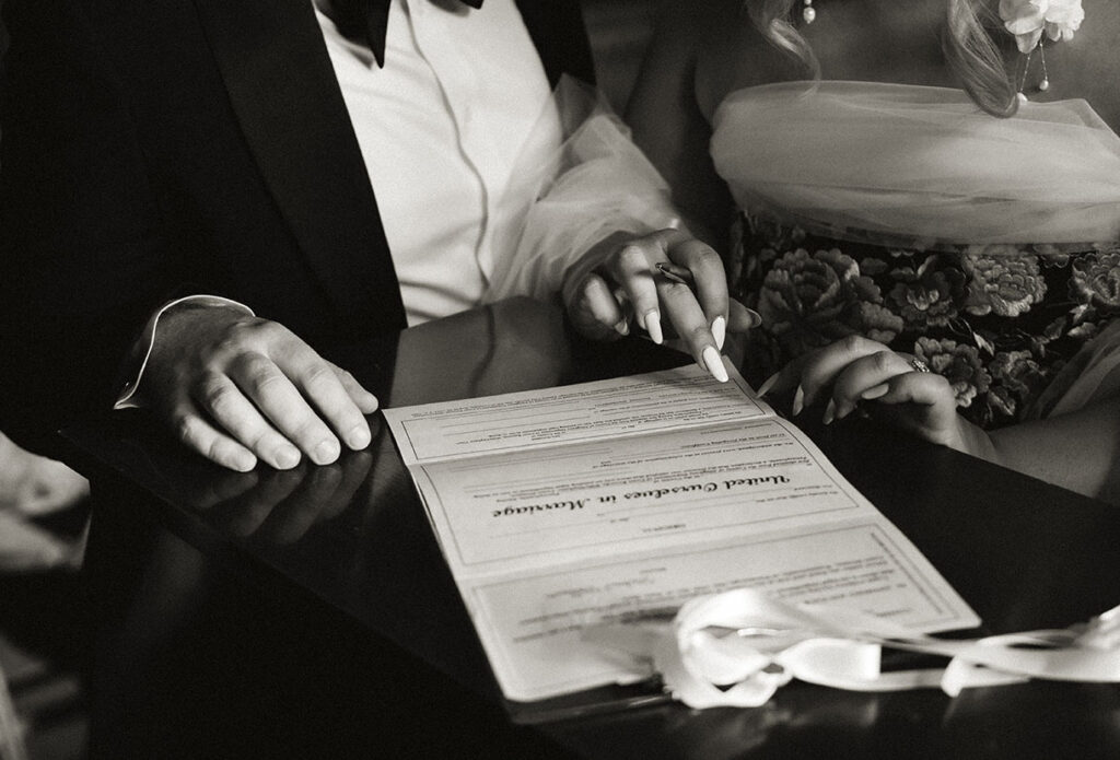 Couple sign wedding certificate at Allegheny County Courthouse