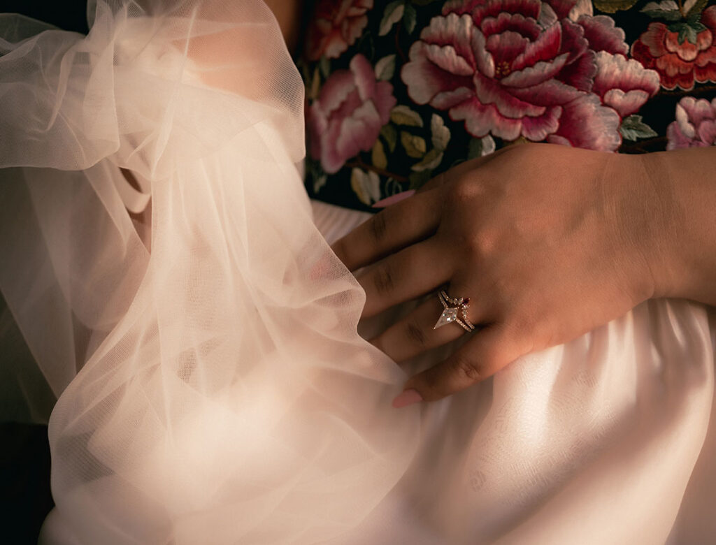 Bride hand showcasing her engagement ring