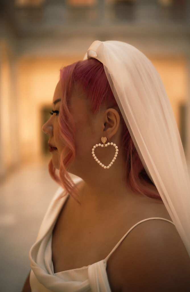 Bride facing away with heart shaped earring at Carnegie Museum of Art 