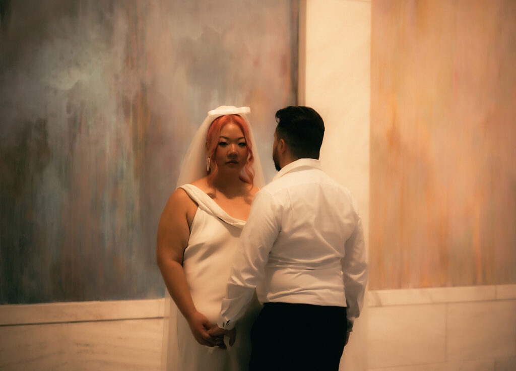 Bride and Groom stand at Carnegie museum of art Hall of Sculpture