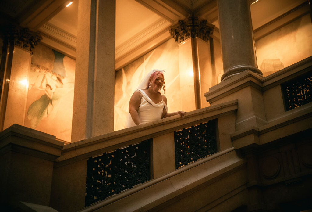 Bride and Groom walk up the grand staircase of Carnegie museum of art in Pittsburgh