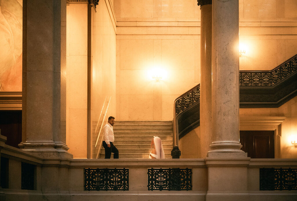 Bride and Groom walk up the grand staircase of Carnegie museum of art in Pittsburgh