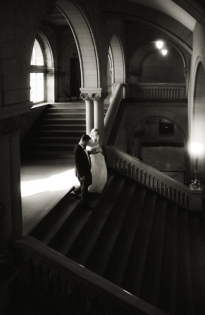 Bride and Groom Going down the staircase of the Allegheny County Courthouse in Downtown Pittsburgh