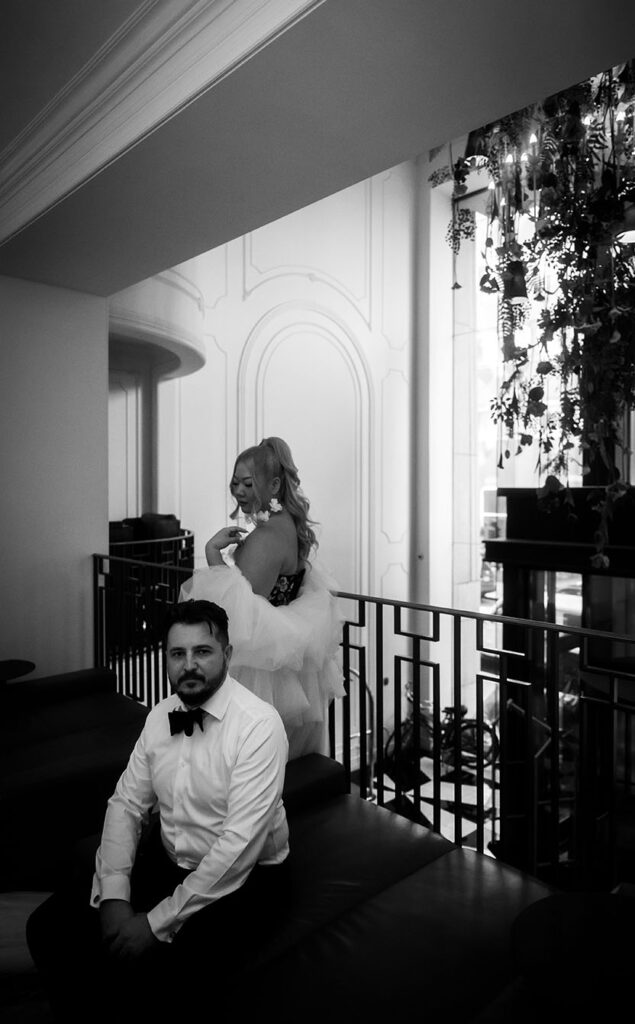 BW Bride and Groom sitting at Kimpton Hotel Monaco lobby