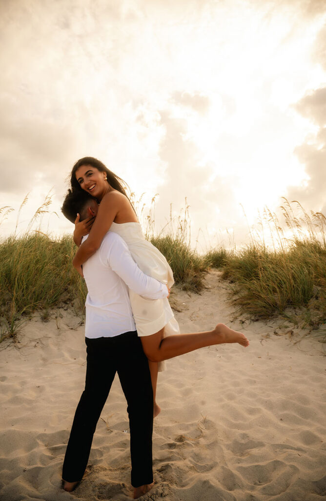 Engaged couple dance in the beach