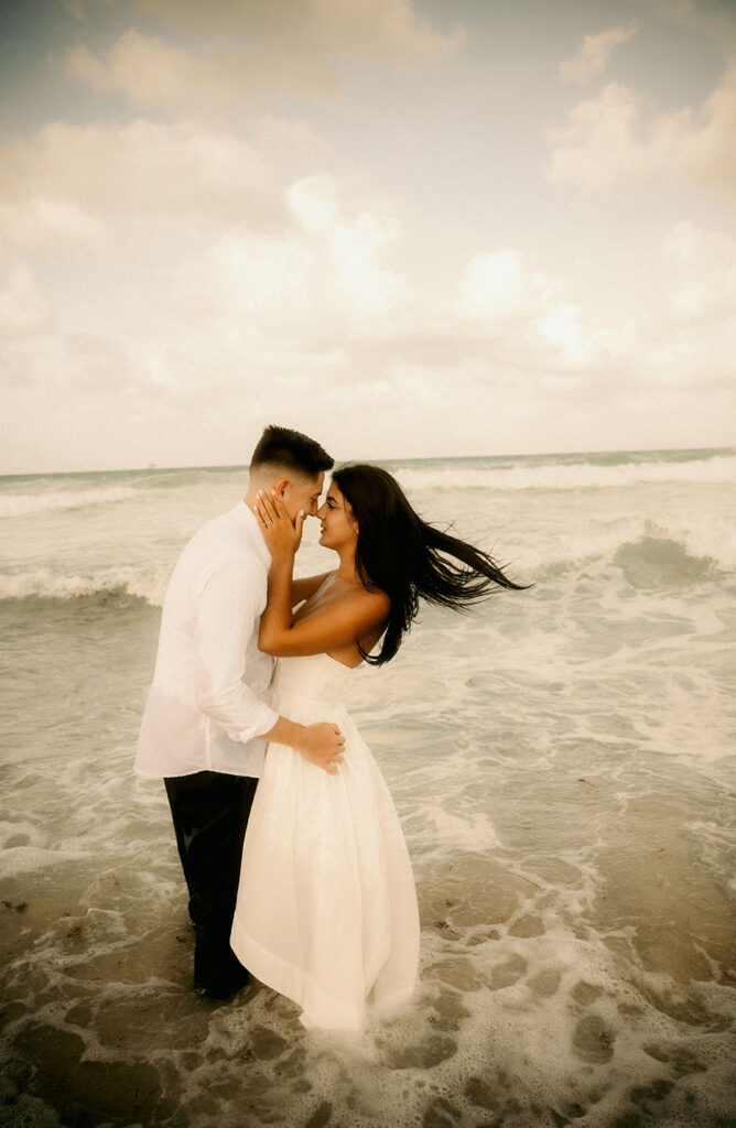 Couple look at each other while in the ocean