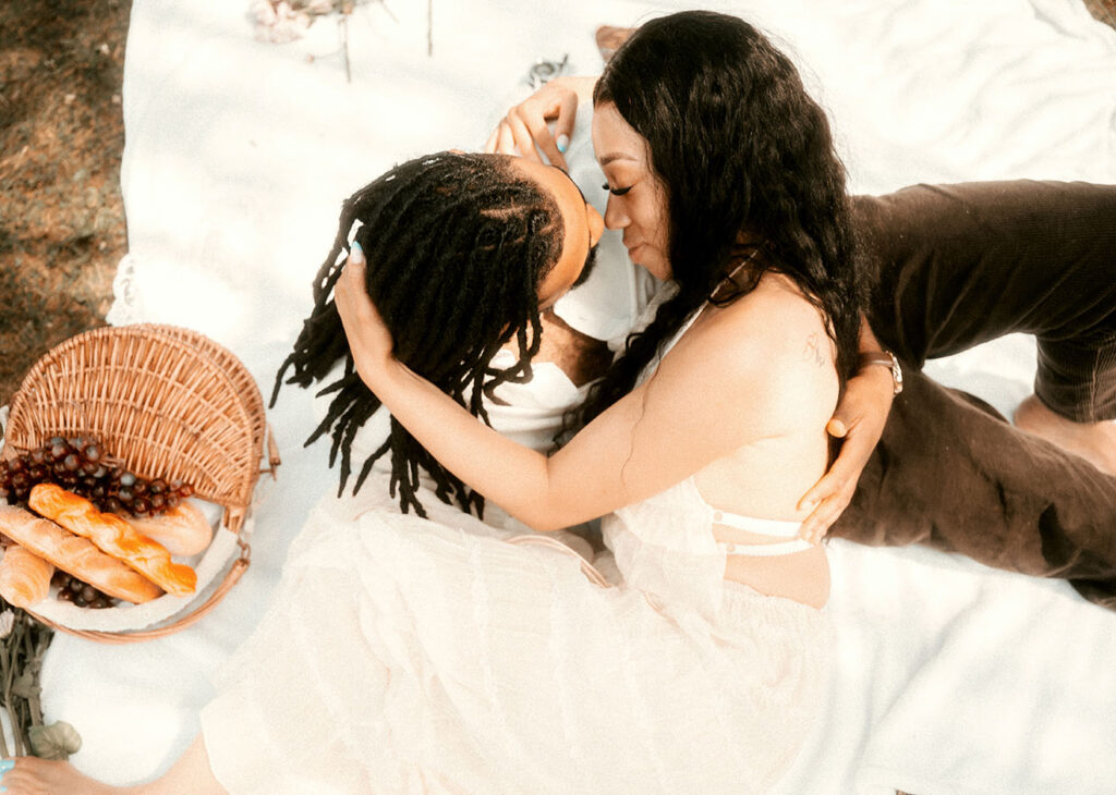 Romantic Couple have pic nic during their summer engagement