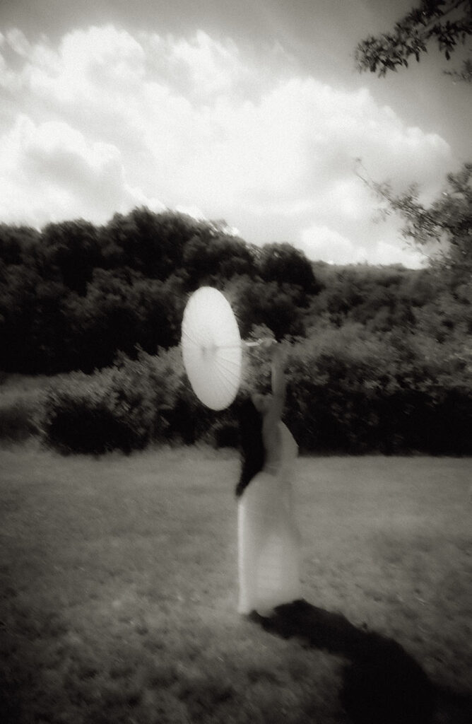 Bride dances with umbrella in engagement photos