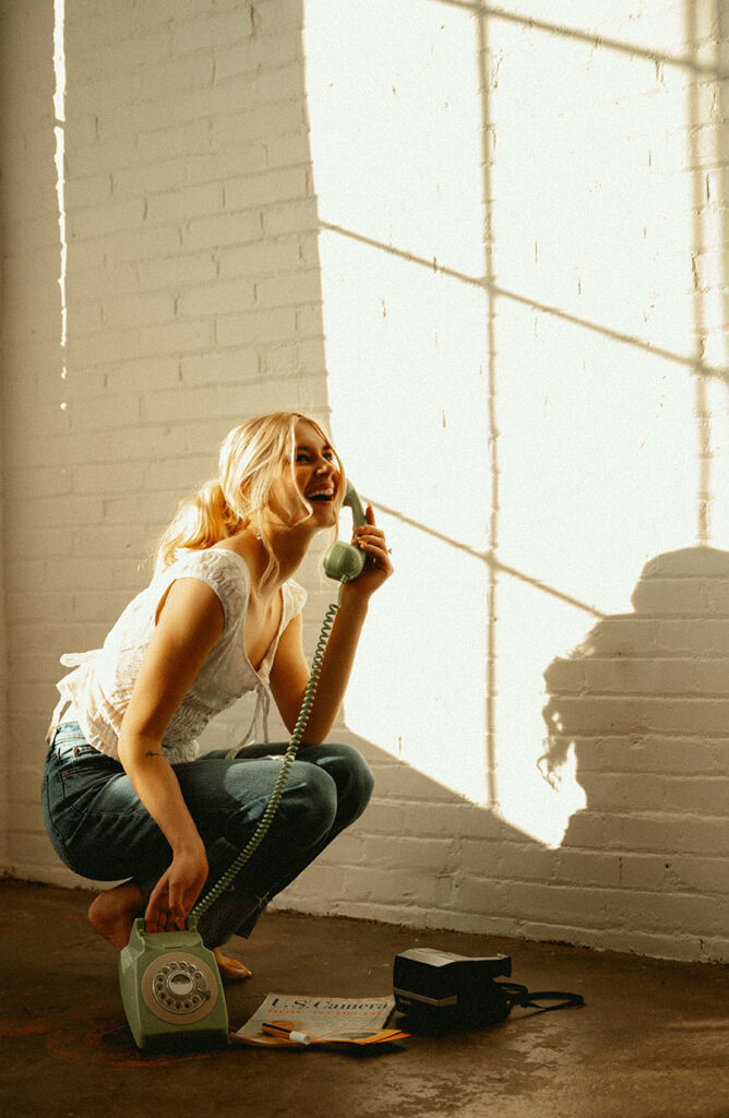 Woman holding a vintage phone in industrial Pittsburgh Building