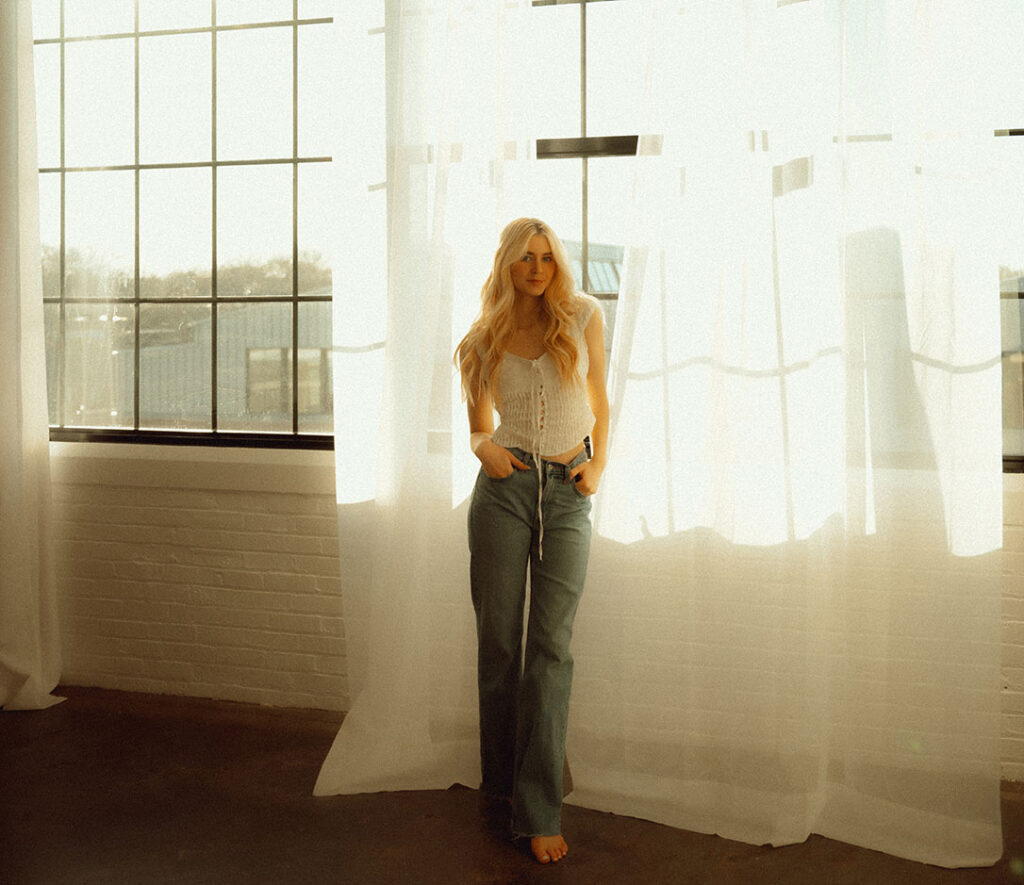 Artistic Photo of woman against curtains