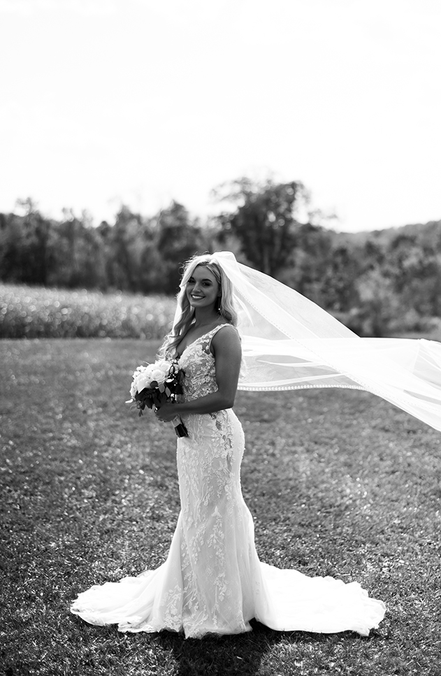 Elegant Bride wearing a Long tight wedding dress with long veil