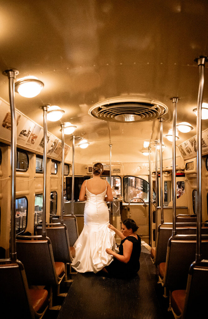 Bride getting her dress bustle in Pittsburgh Trolly at Heinz Wedding