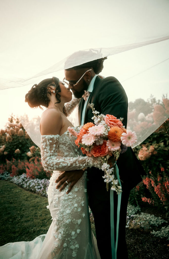 Bride and Groom about to kiss under bride's veil