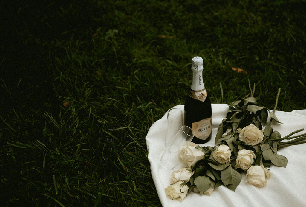 Champagne with white roses by documentary wedding photographer