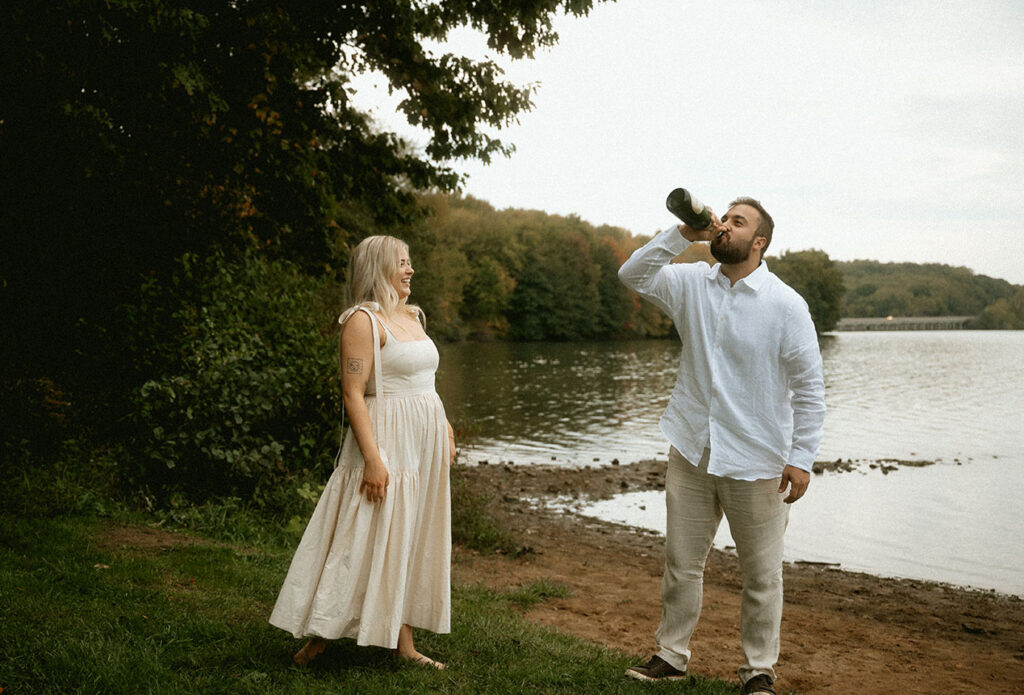 BW Couple pop Champagne bottle celebrating their engagement in Moraine State Park