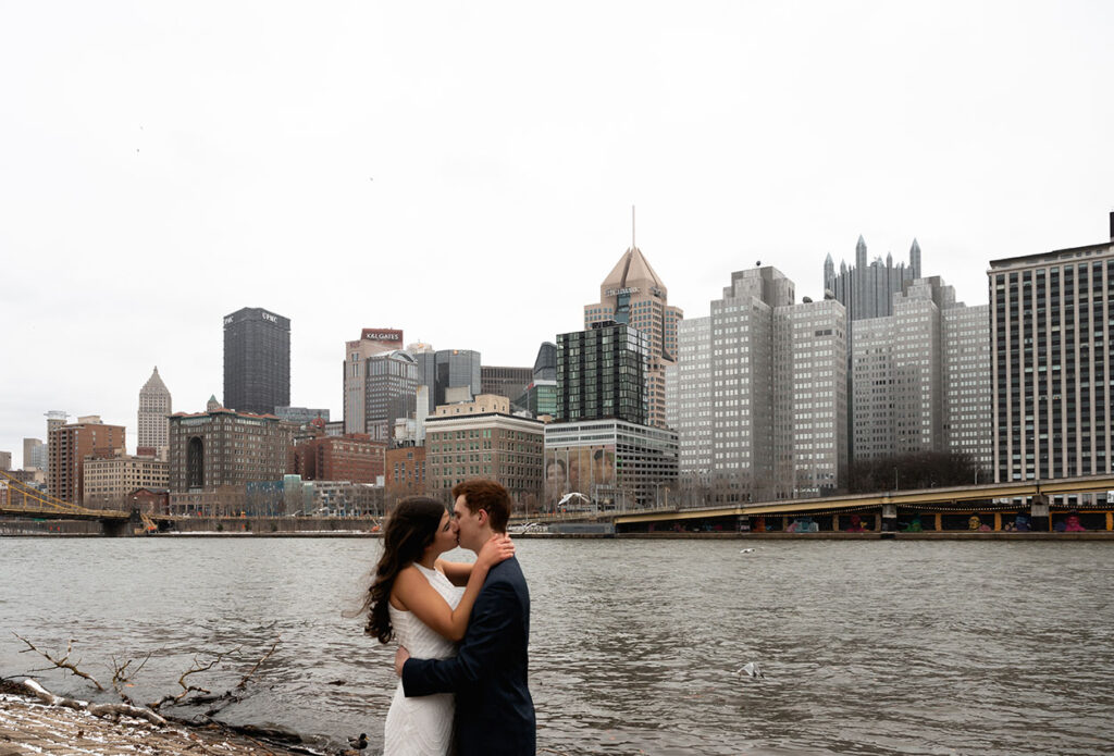 Couple kiss in front of Downtown Pittsburgh Skyline