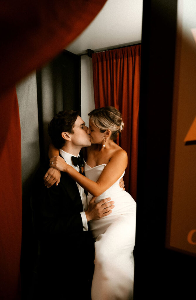 Couple kiss in Andy Warhol Photo Booth during their wedding