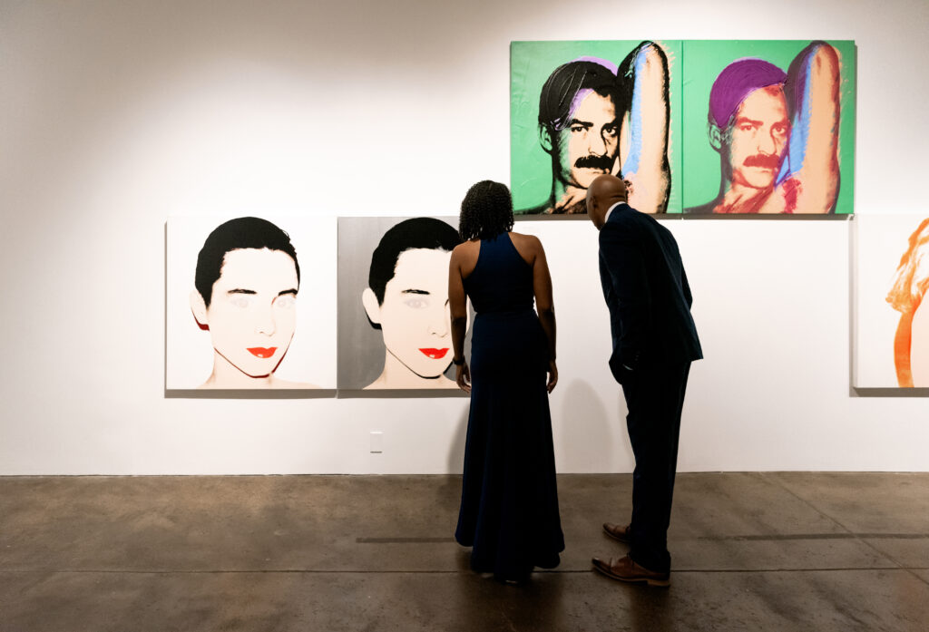 People looking at Art during Andy Warhol during wedding reception