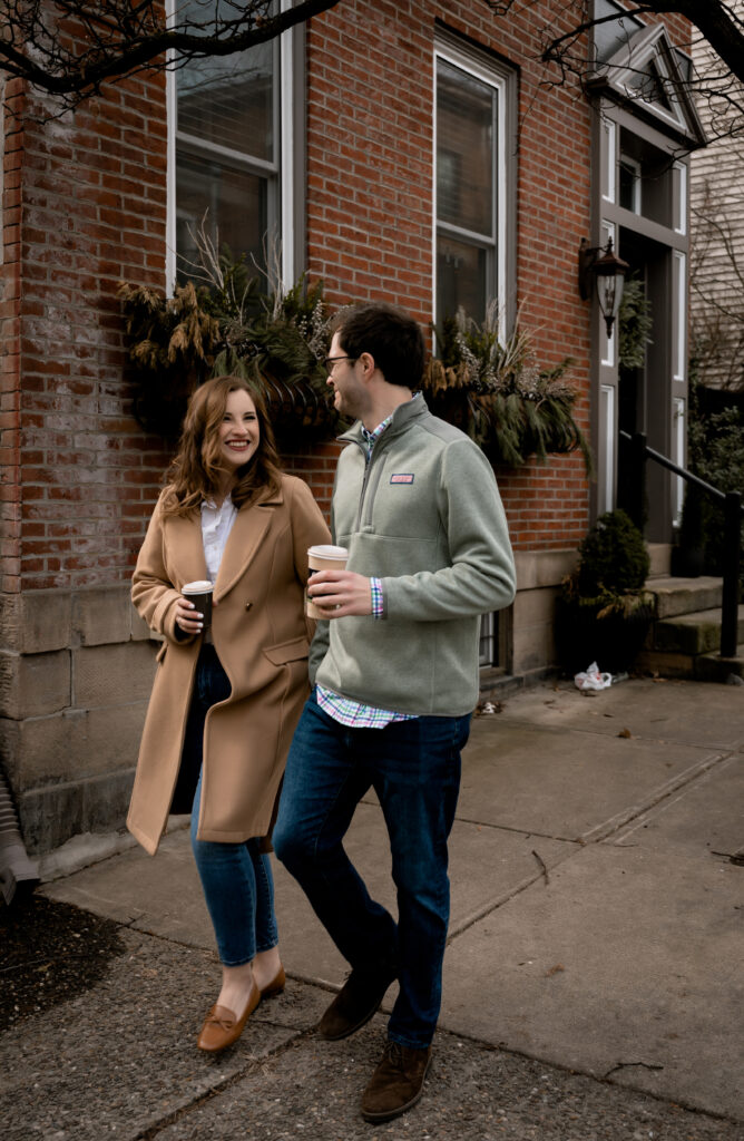 Couple walk down the Mexican War Streets.while holding coffee