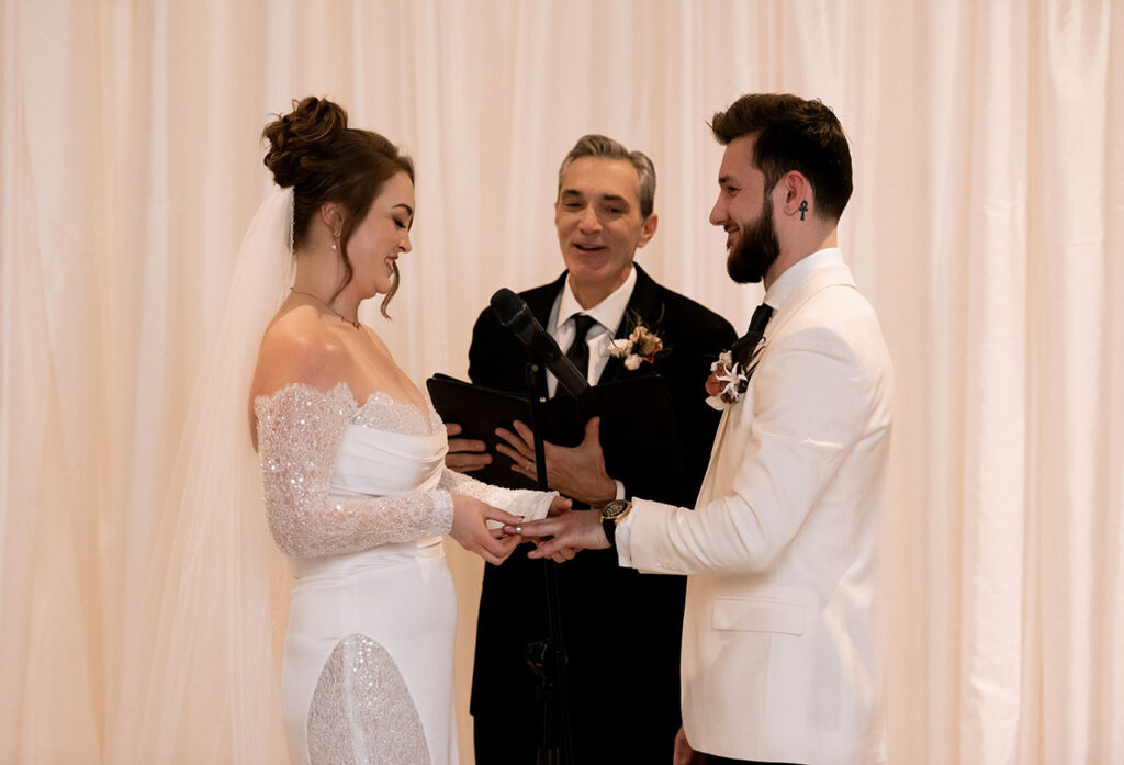 Bride putting Groom's ring at Museum Lab Wedding Ceremony