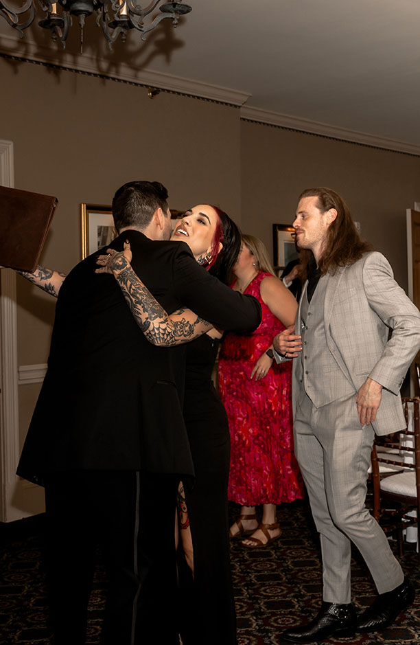 Groom hugs friends at Shelby Club Wedding