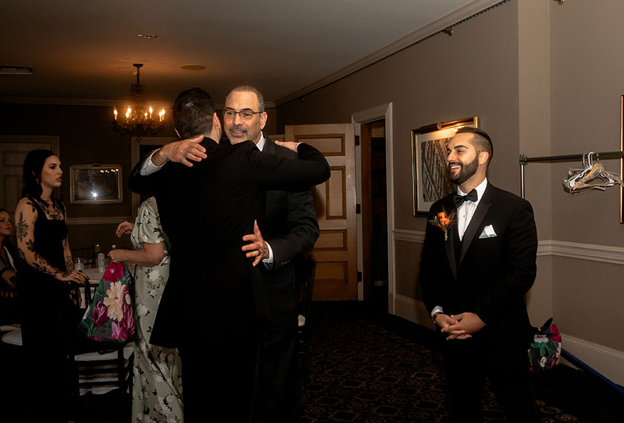 Groom and father hug