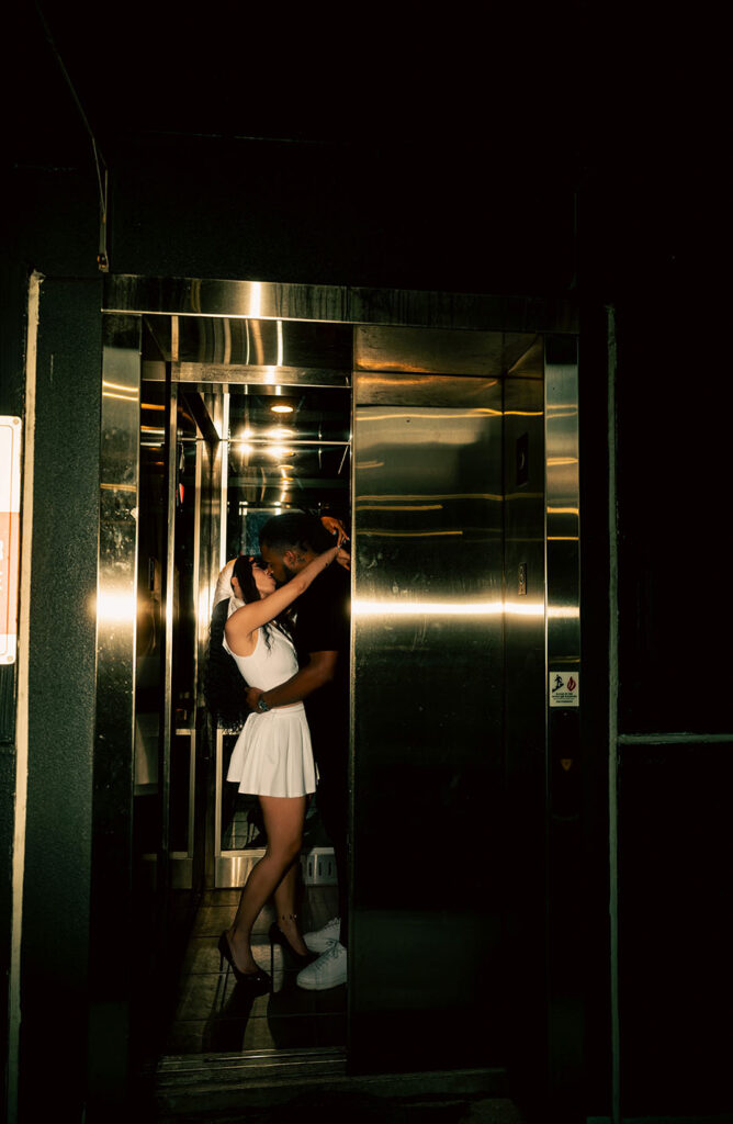 Couple kiss as elevator's door closes