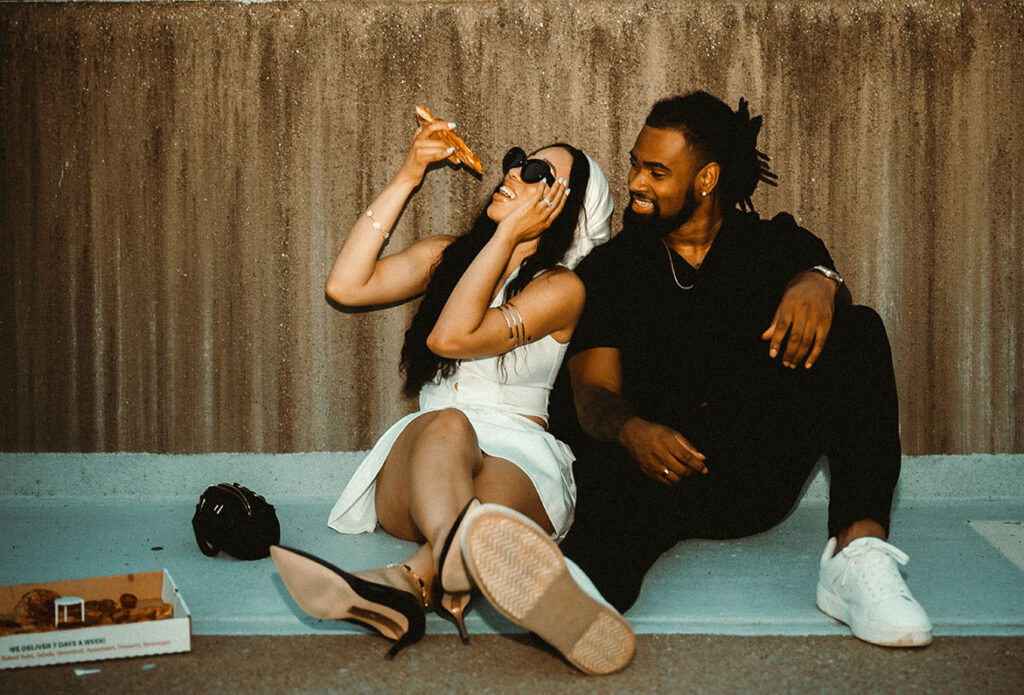 Couple eating Pizza during their engagement photo shoot in Pittsburgh