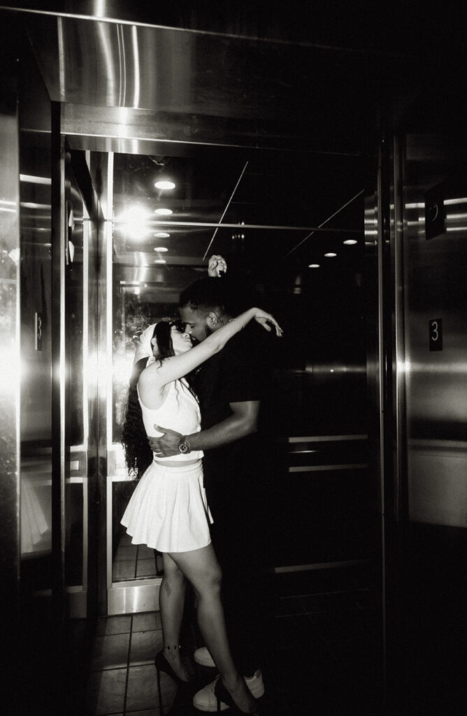 BW couple kissing in elevator