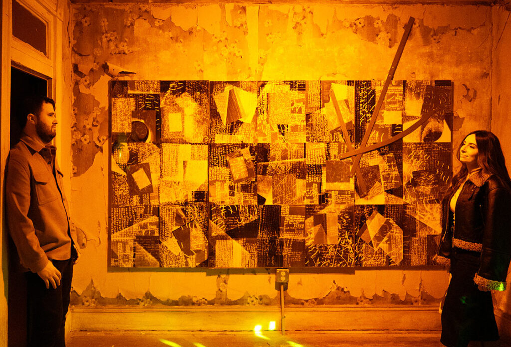 Couple Looking at weach other with mural in the background in Mattress Factory Museum