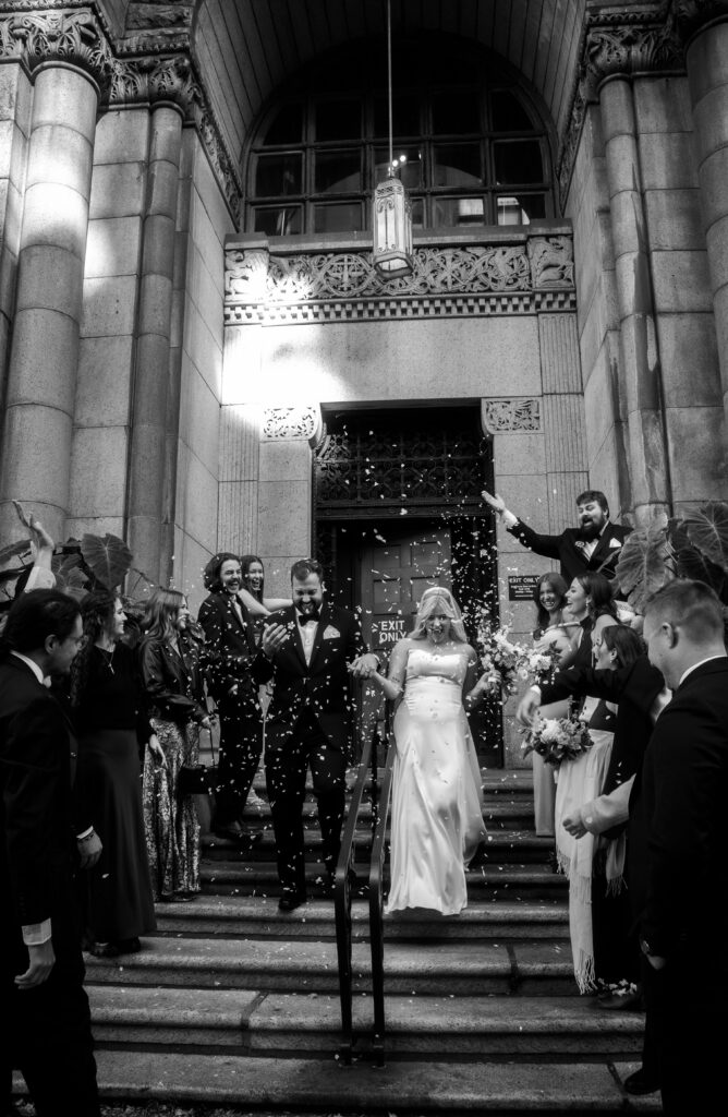 Bride and Groom Exit their wedding while friends throw roses