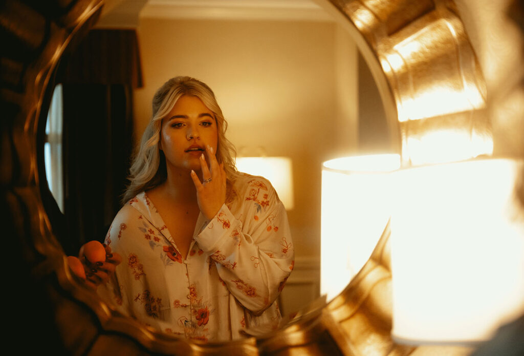 Bride looking at herself in mirror