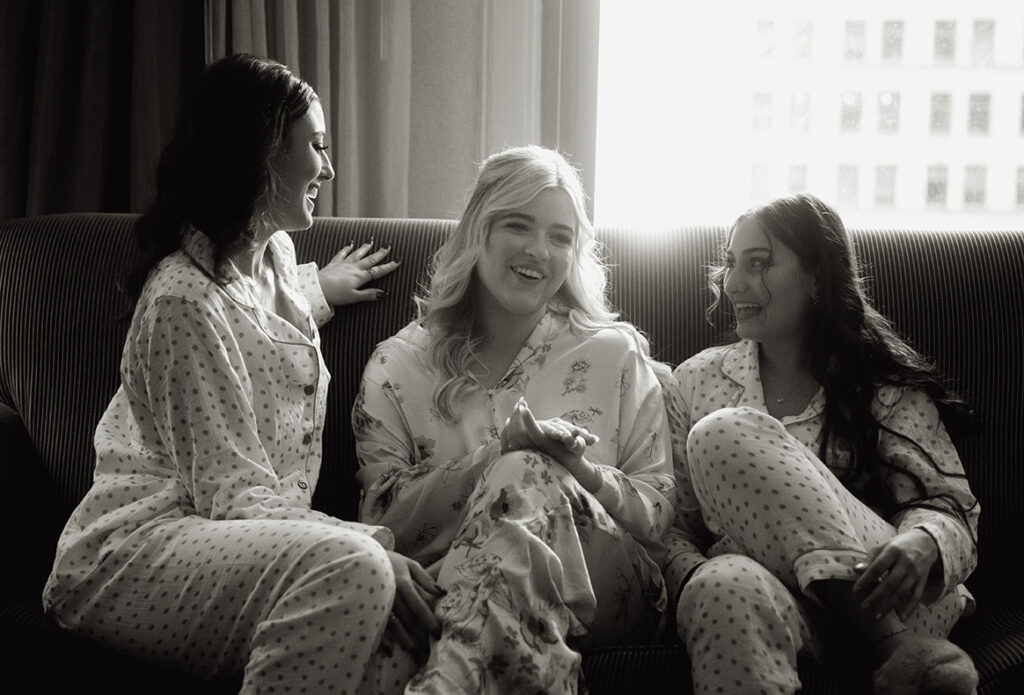 Bride and Bridesmaids laughing in their sofa