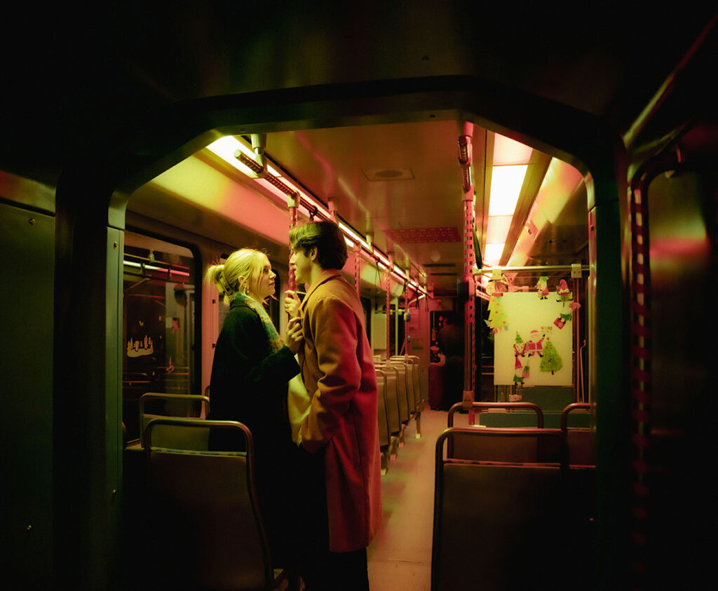 Couple standing in the train facing each other