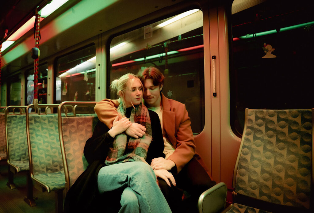 Couple sitting at Subway Train Holding embracing each other