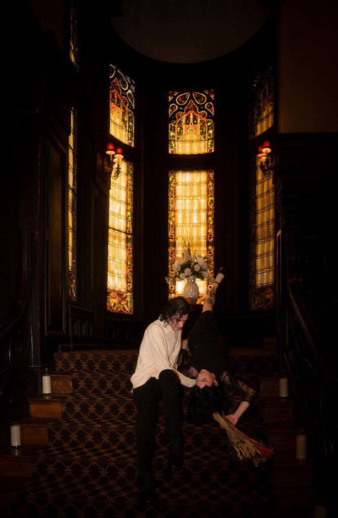 Mansion on 5th Engagement Couple Laying on grand staircase