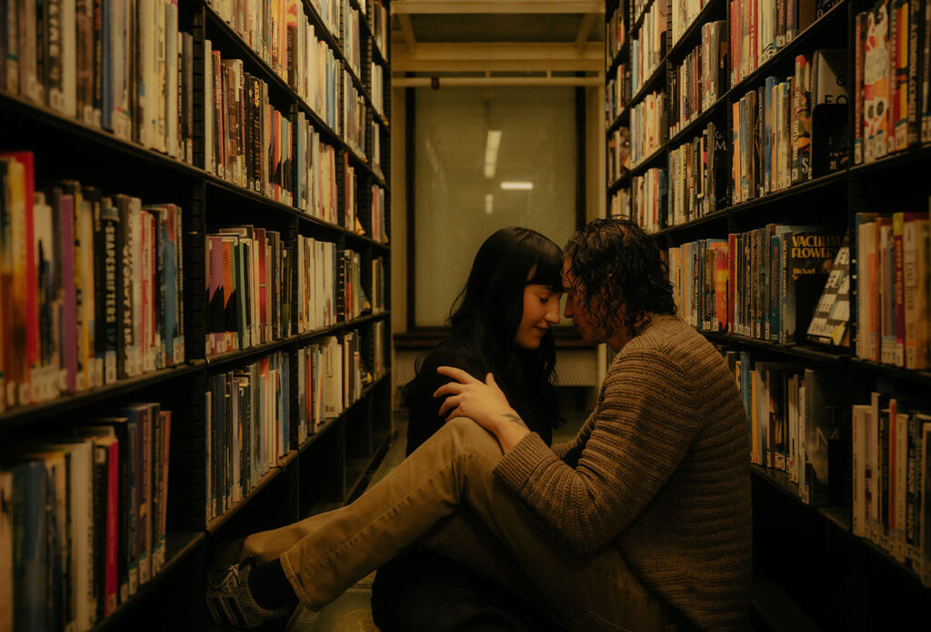 Couple sitting at Carnegie Library surrounded by books