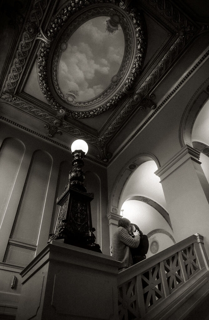 Couple Kiss at Carnegie Library Grand Staircase with ceiling art