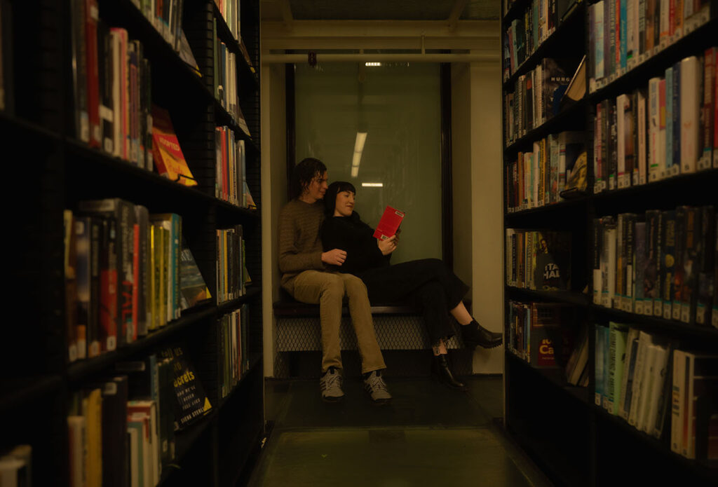 Couple reading at Carnegie Library surrounded by books