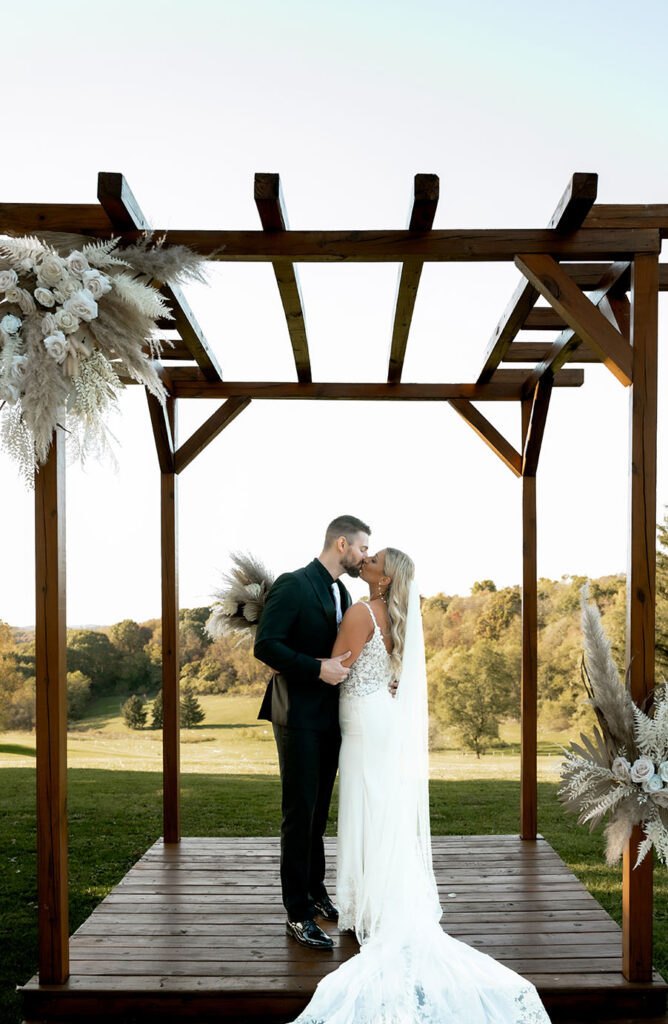 Bride and Groom Kiss at their yinzer valley farms Wedding Altar