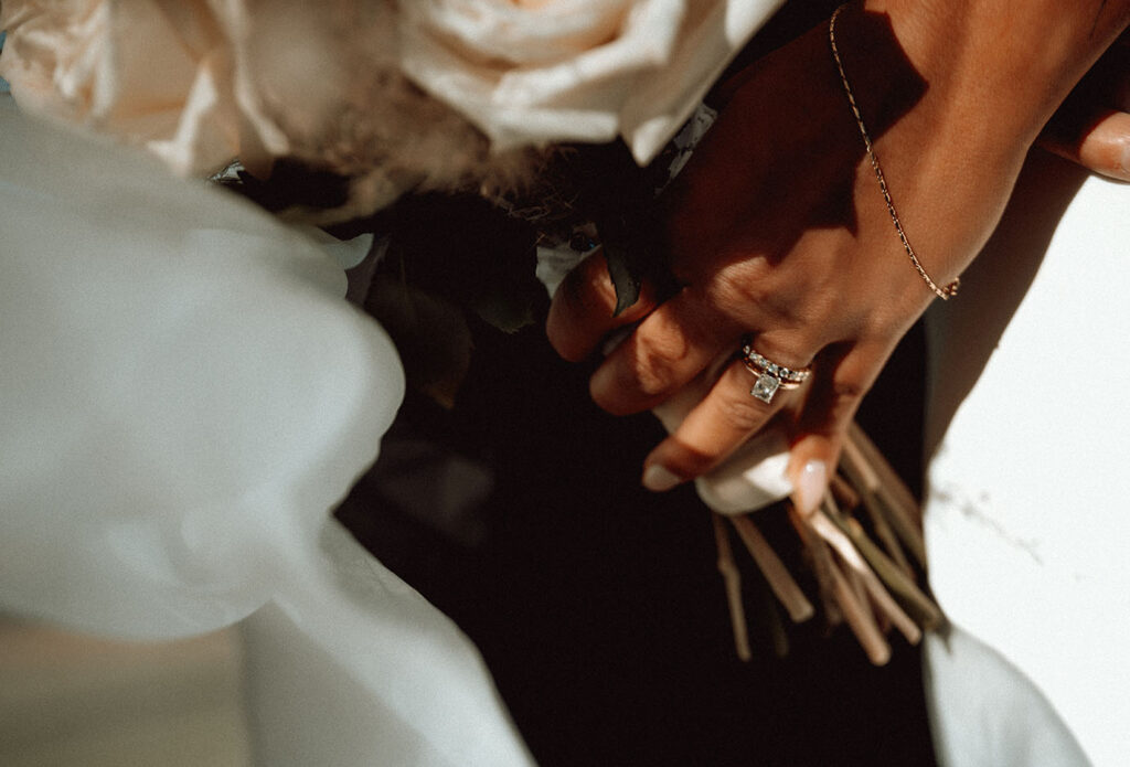 Bride holding bouquet with her ring