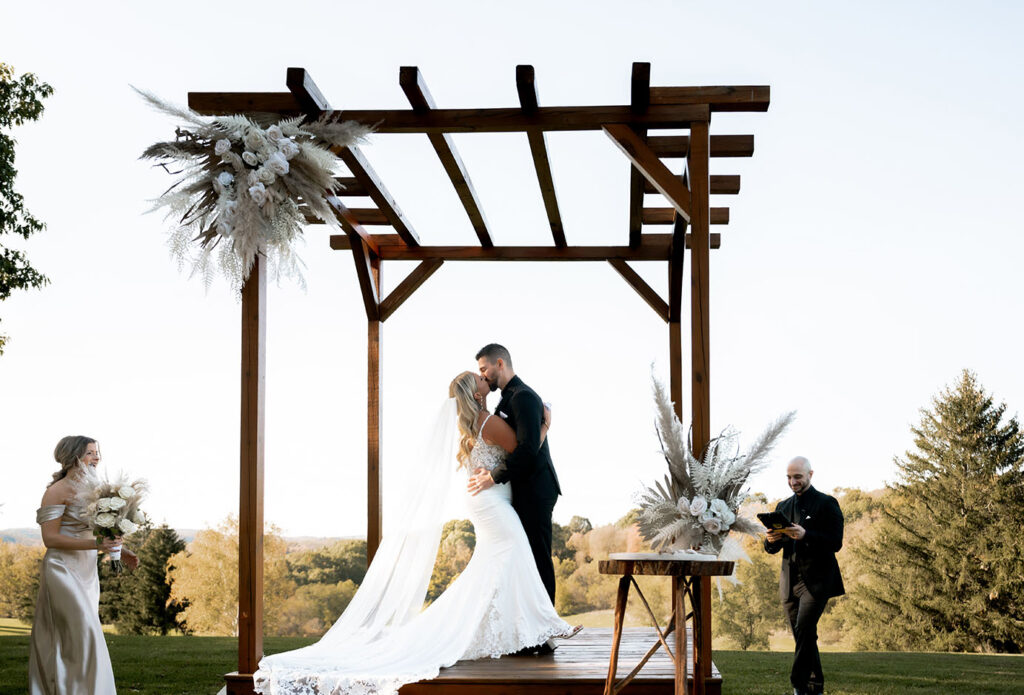 Bride and Groom Kiss at yinzer valley farms Wedding Altar