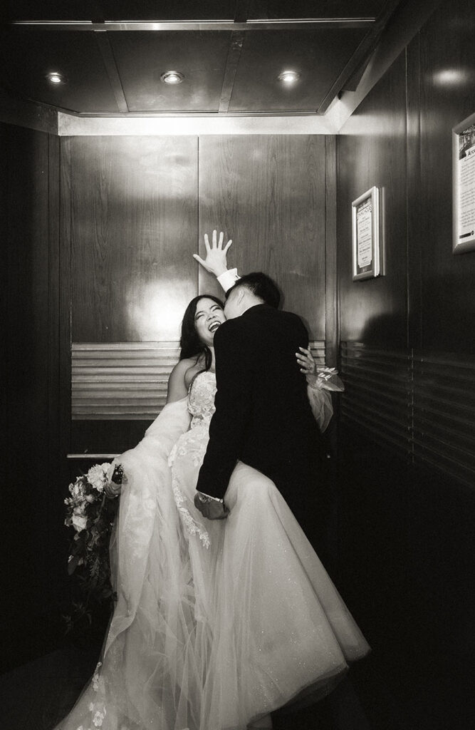 Bride and Groom at an elevator during their wedding at the Arcade