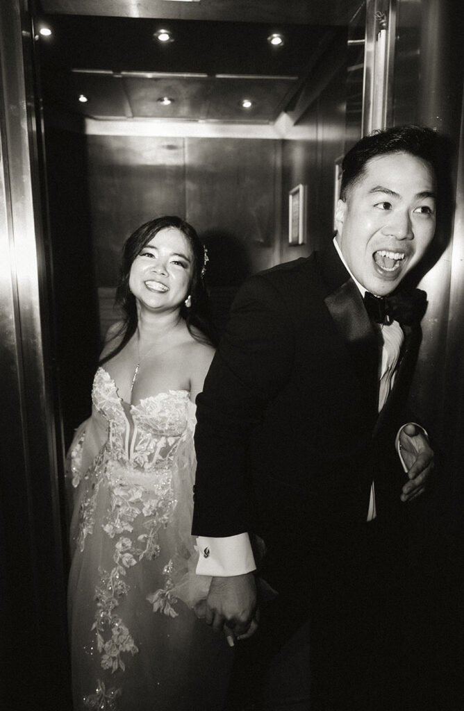 Bride and Groom at an elevator during their wedding at the Arcade